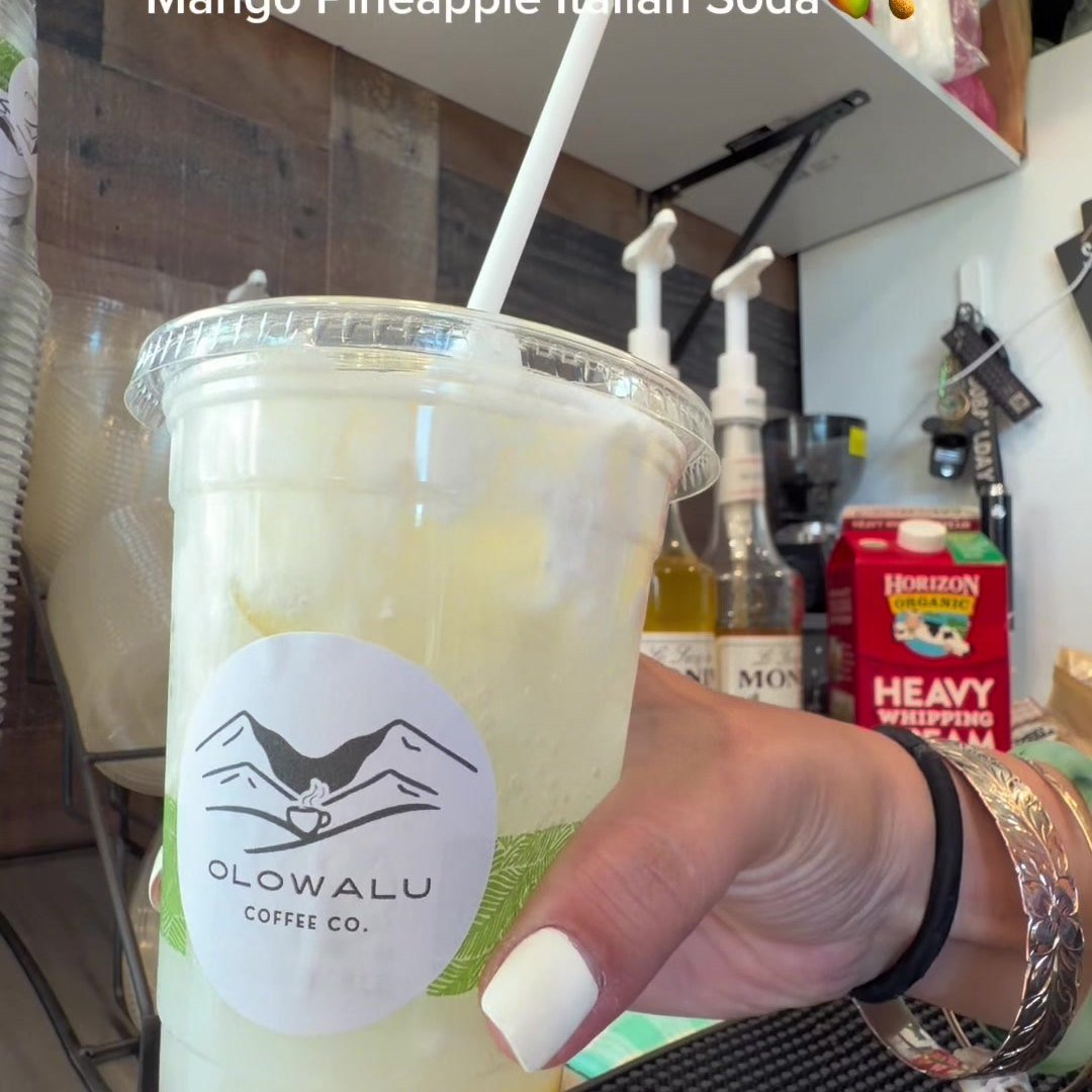 A mango pineapple Italian soda in an Olowalu Coffee Co cup.