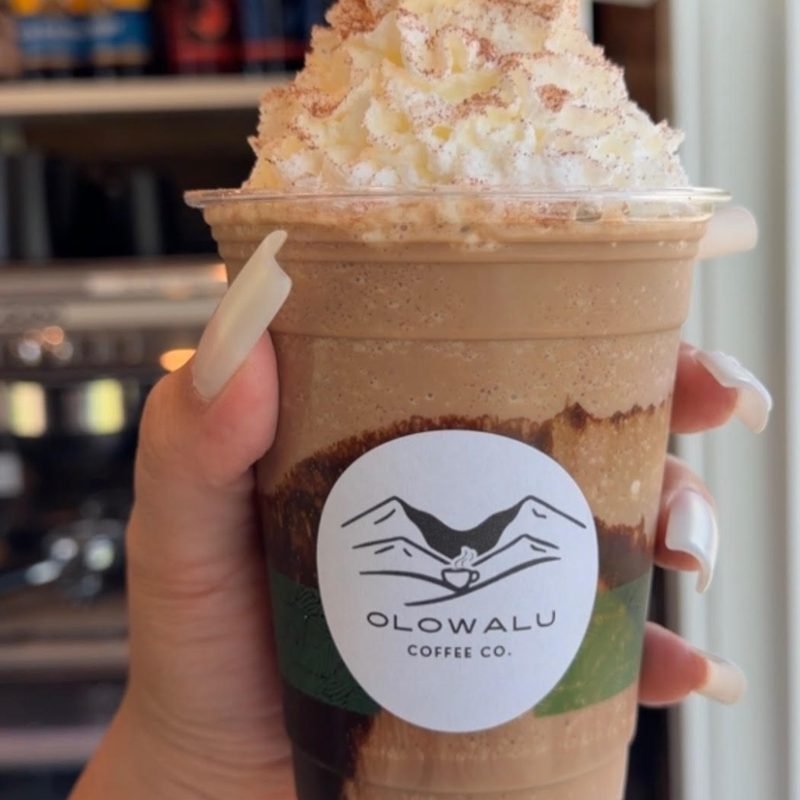 A blended double chocolate mocha with whipped cream in an Olowalu Coffee Co cup.