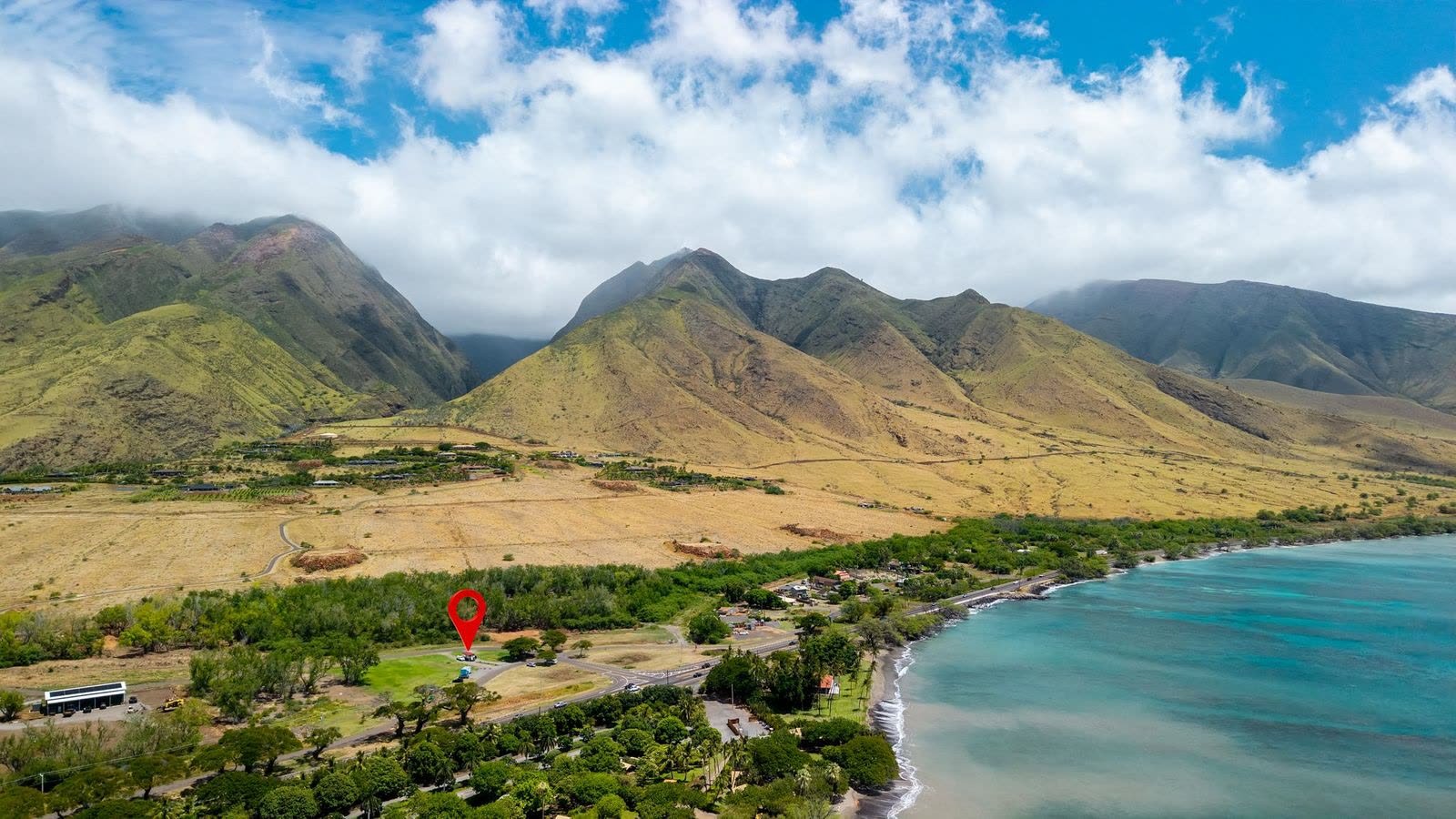 An aerial view of the Olowalu valley and shoreline with a map pin marking the Olowalu Coffee Co trailer.