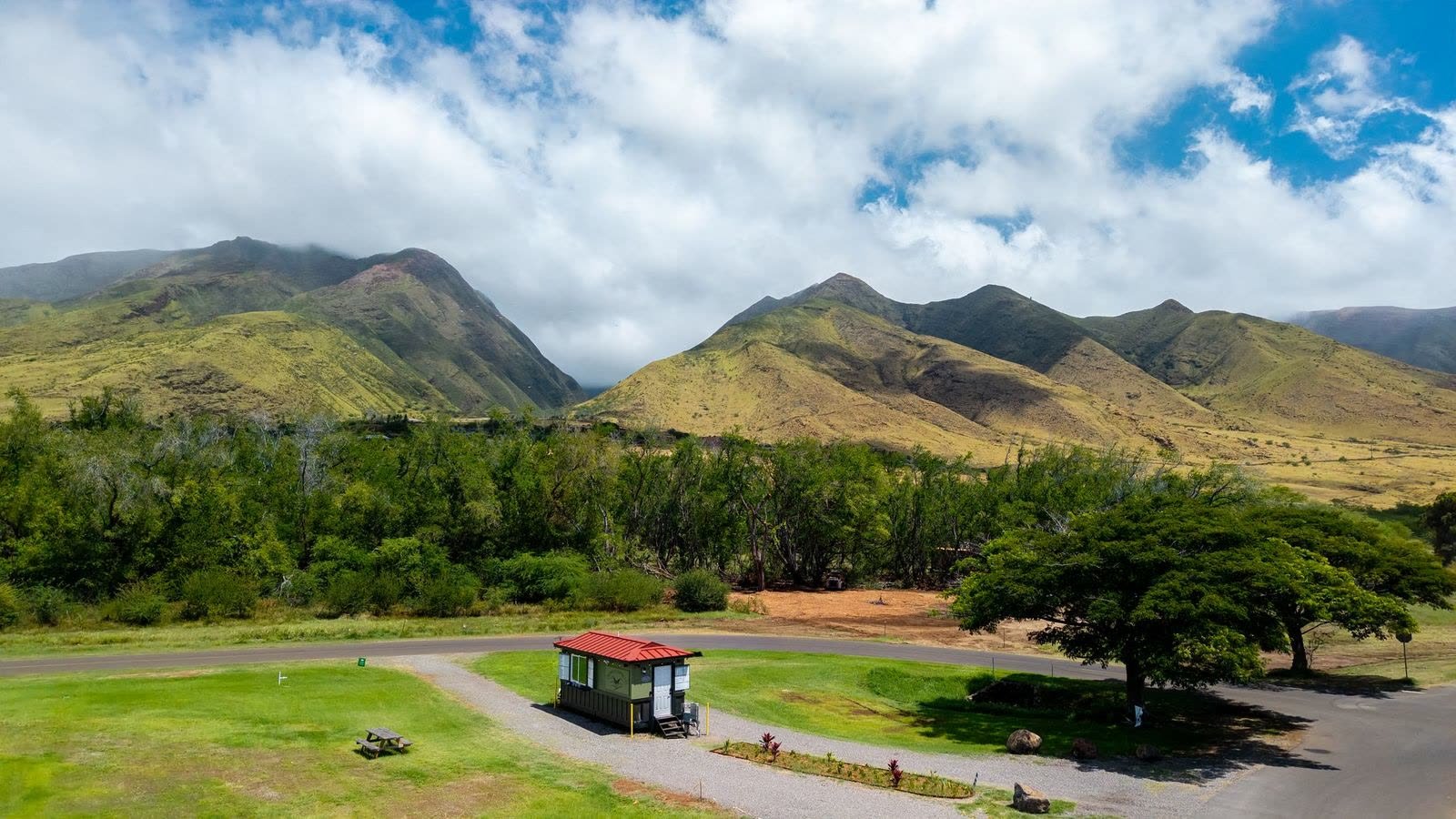 The Olowalu Coffee Co trailer on its lawn, with the West Maui mountains rising behind it.